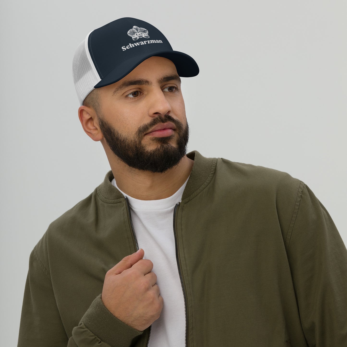Navy and white retro trucker hat with orchid emblem – Schwarzman