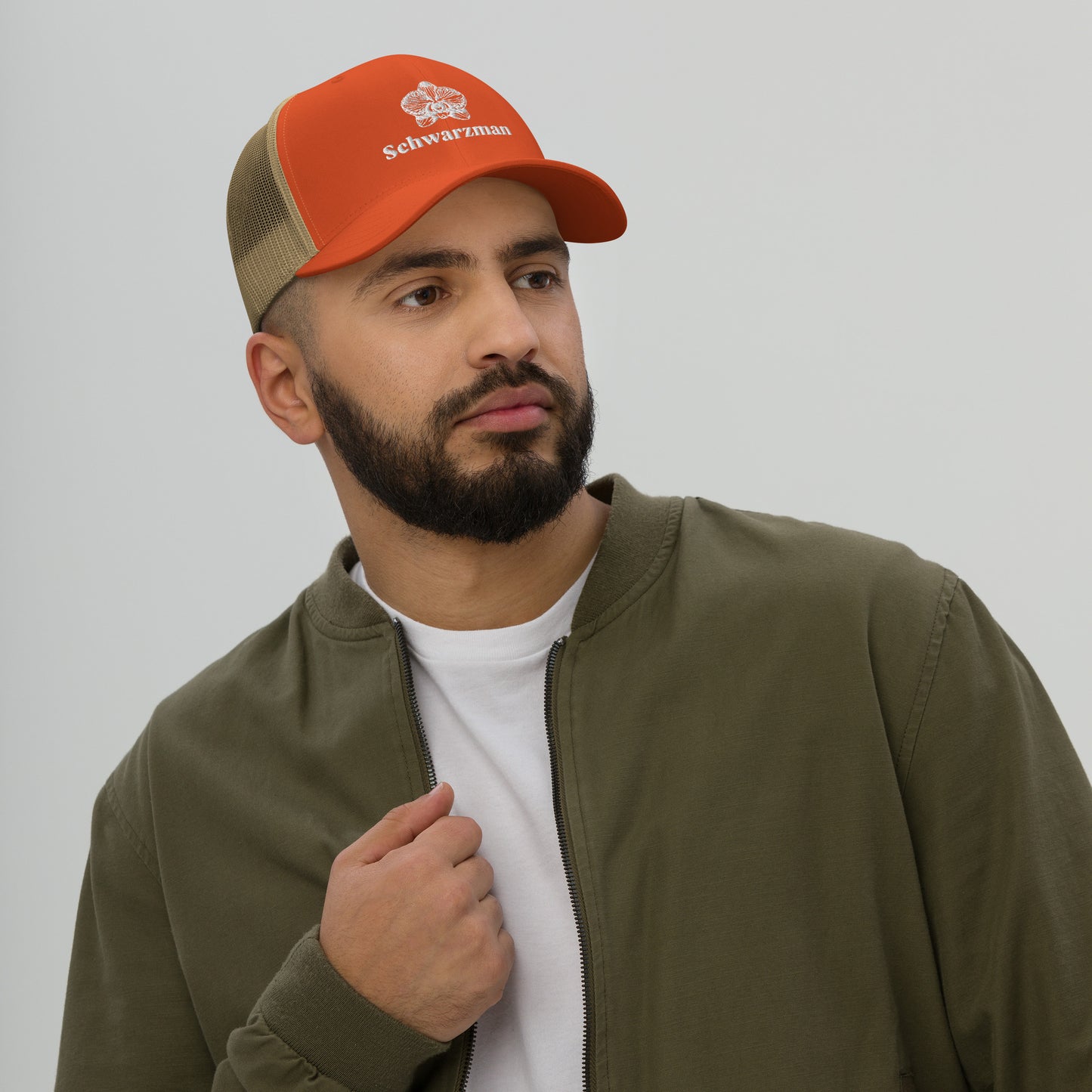 Rustic orange khaki retro trucker hat with orchid emblem – Schwarzman